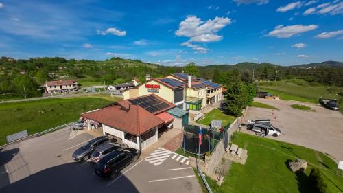 an aerial view of a house with cars parked in a parking lot at Pension Patrik in Hrušica