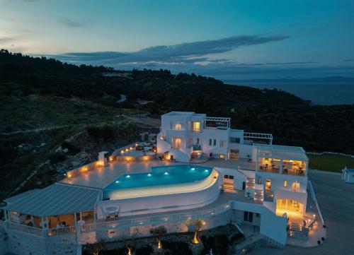 a large white house with a swimming pool at Cavo del Sol in Sarti