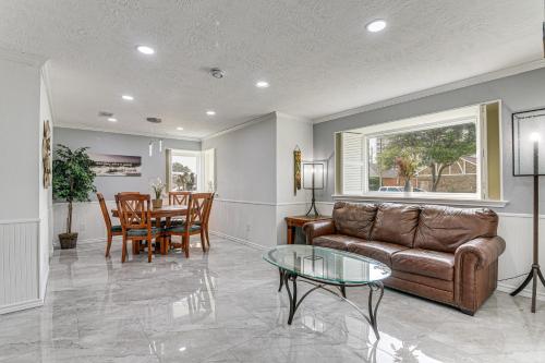a living room with a couch and a table at about 2 Blocks to Beach Galveston Group Getaway! in Galveston