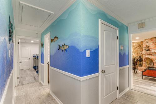 a hallway with a blue wall with fish painted on it at about 2 Blocks to Beach Galveston Group Getaway! in Galveston