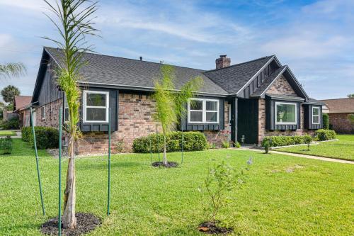 a house with a palm tree in the yard at about 2 Blocks to Beach Galveston Group Getaway! in Galveston