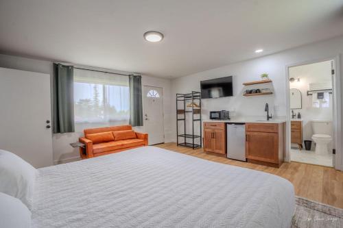 a bedroom with a large bed and a kitchen at The Inn at Shady Pines in Gros Cap