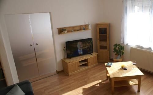 a living room with a television and a table at Ferienhaus Johanna in Alberthain