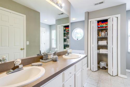 a bathroom with two sinks and a large mirror at Home Sweet Home with Private Pool and Patio! in Knoxville