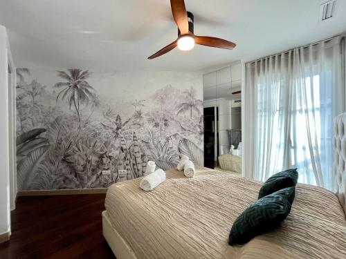 a bedroom with a large bed with a ceiling fan at WeRentVLC - Design Ruzafa - Top location in Valencia