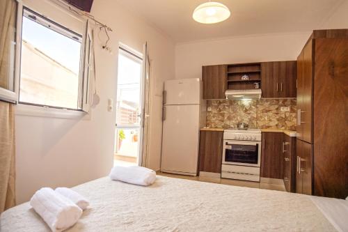 a kitchen with a large bed with two towels at Baloma Studio in Áyios Fótios