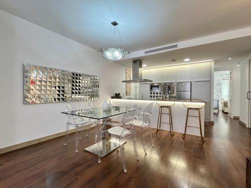 a kitchen with a glass table and stools in it at WeRentVLC - Design Ruzafa - Top location in Valencia