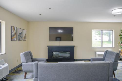 a living room with two couches and a fireplace at Days Inn by Wyndham Mount Vernon in Mount Vernon