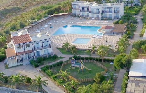 an aerial view of a house and a swimming pool at Sweet Kalimera Apartments in Kardamaina