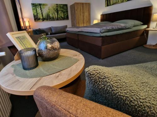 a living room with two beds and a table at Forsthaus Garz in Garz