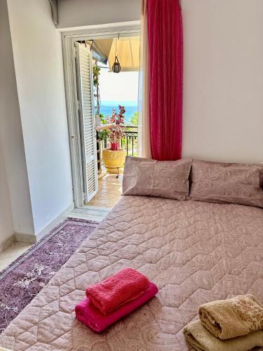 a bedroom with a large bed with red pillows on it at Bratis House Arkoudi in Arkoudi