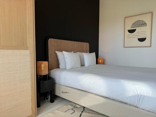 a bedroom with a bed with white pillows at 3 Room Luxury Design Apartment with Airconditioning, Close to Gent St-Pieters Station in Ghent