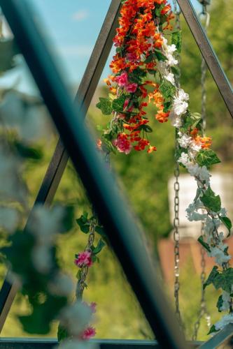 a mirror reflection of flowers hanging from a chain at Paradise Keda in Keda
