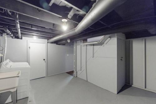 a large room with white cabinets and a sink at The Playmakers Funhouse-HOF Village in Canton