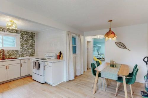 a kitchen and dining room with a table and chairs at The Playmakers Funhouse-HOF Village in Canton