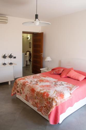 a bedroom with a large bed with a red blanket at Palazzo Spagna in Siracusa