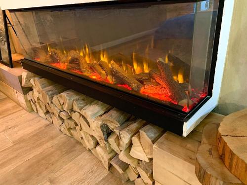 a large aquarium in a living room with a fireplace at Boutique apartment in heart of Haifa in Haifa