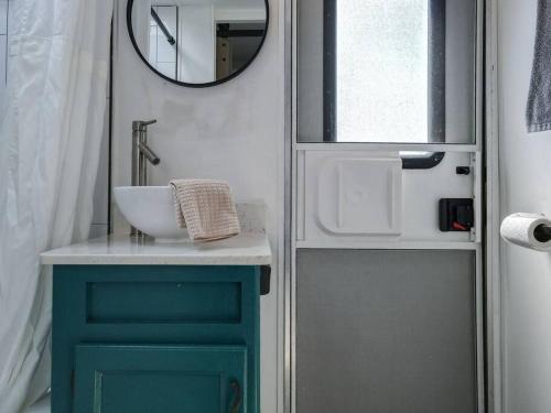 a bathroom with a sink and a mirror at Wildflower Wanderlust-Glamping st 1885 Farms in Navarre