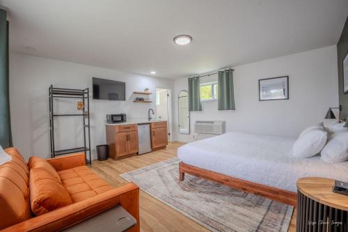 a large bedroom with a bed and a couch at The Inn at Shady Pines in Gros Cap