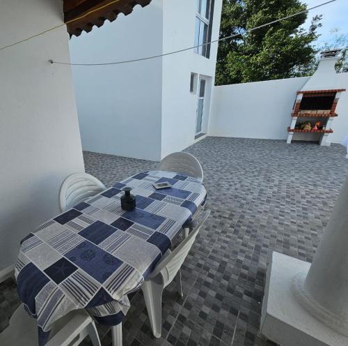 a blue and white table and chairs on a patio at Casa dos Amigos in Ponta Delgada