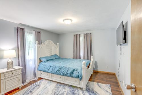 a bedroom with a white bed and a tv at Lake Erie Family Getaway in Amherst Pets Welcome! in Amherst