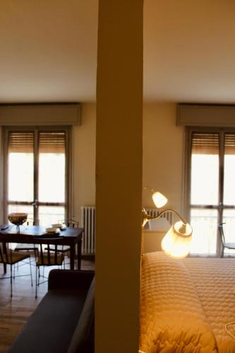 a bedroom with a bed and a dining room with a table at Art Hotel Pandos in Tabiano