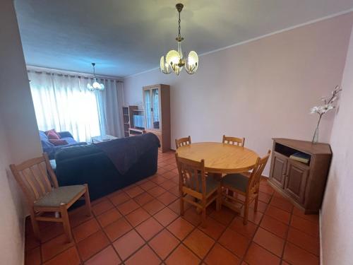 a living room with a table and a couch at Rosário - two bedroom apart- Buarcos - Figueira da Foz in Figueira da Foz