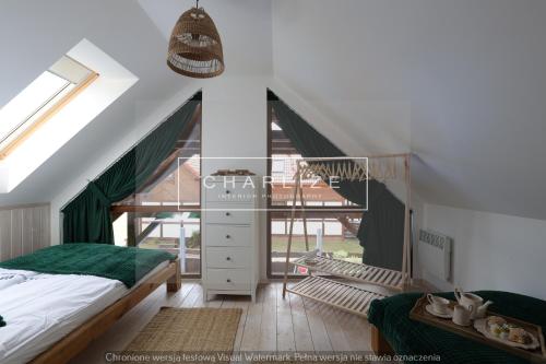 a bedroom with a bed and a large window at Ale Lipa - Ostoja Bukowo in Borowy Młyn