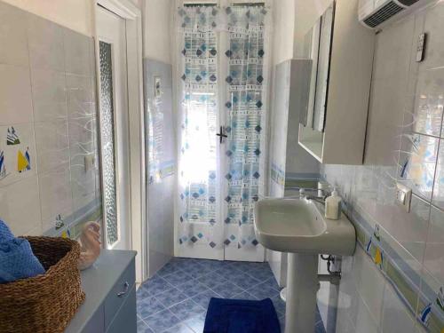 a bathroom with a sink and a shower at Casa Ginny in Ospedaletti