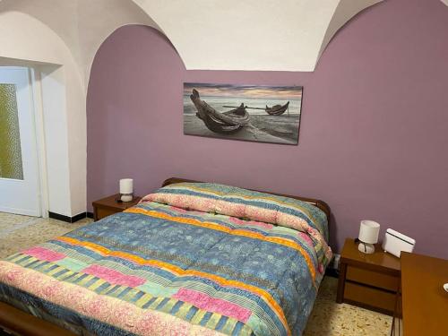 a bedroom with a bed with two boats on it at Casa Ginny in Ospedaletti