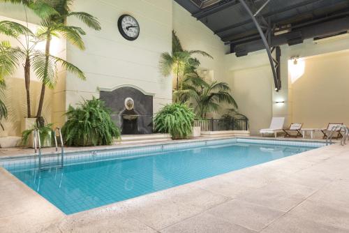 a large swimming pool with a clock on the wall at Loi Suites Recoleta Hotel in Buenos Aires