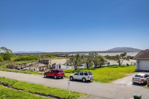 three cars parked in a parking lot next to a beach at Sleek Ferndale Home with Ocean and Mountain Views! in Ferndale