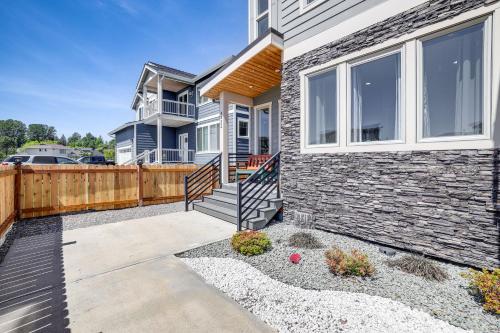 a home with a staircase and a fence at Sleek Ferndale Home with Ocean and Mountain Views! in Ferndale