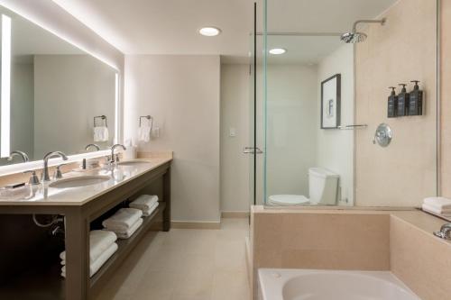 a bathroom with two sinks and a shower at Sheraton Puerto Rico Resort & Casino in San Juan