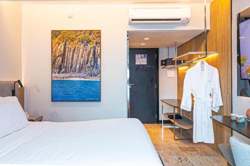 a bedroom with a white bed and a desk at Hotel Atlante Plaza in Recife