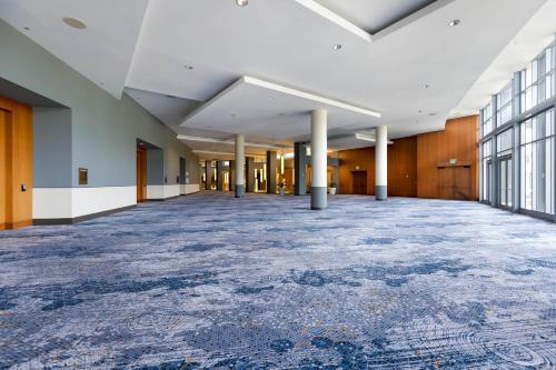 an empty hallway of an office building with a large rug at Sheraton Puerto Rico Resort & Casino in San Juan