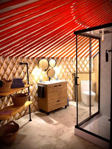 a bathroom with a sink and a toilet in a room at Yurta Arco Iris in Riba-Roja De Turia