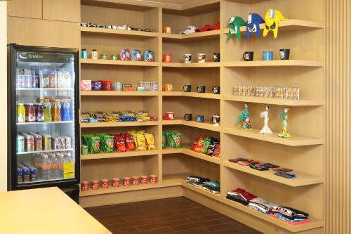 a refrigerator in a room with lots of shelves at Holiday Inn Tijuana Zona Rio by IHG in Tijuana