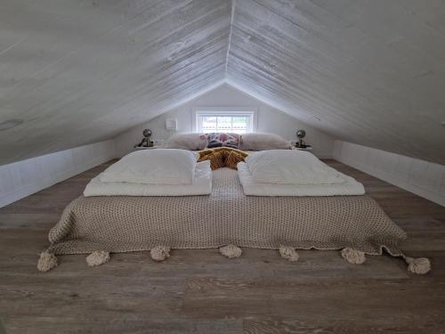 a bedroom with two beds in a attic at Charmant hus med bastu och braskamin in Alingsås