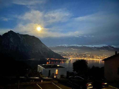 a view of a city and the moon over the water at Casa Bellavista in Pugerna