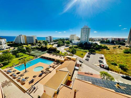 a view of a city with a pool and buildings at Paradise Sunshine Studio in Portimão