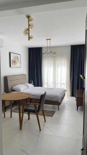 a bedroom with a bed and a table in it at Przno Apartment Most Oliva in Vrijesno