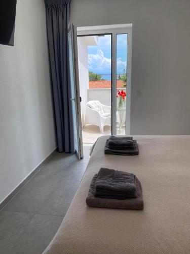 two towels on a bed in a room with a view at Seaview Kamenjak in Premantura