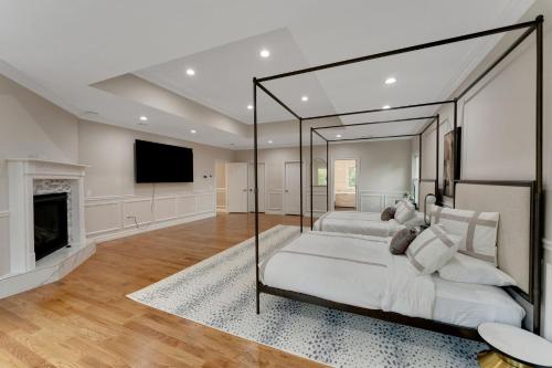 a bedroom with a large bed and a fireplace at The President Mansion Luxurious 7BR Family Retreat in Bay Shore