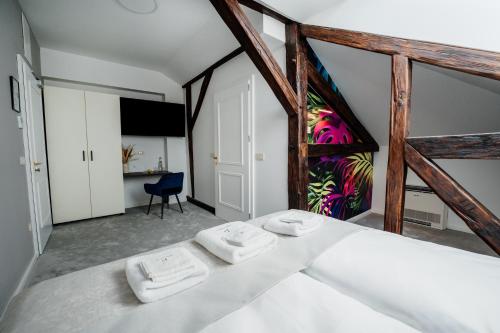 a bedroom with two white towels on a bed at GRAND CENTRAL LJUTOMER in Ljutomer