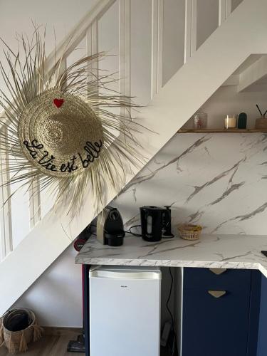 une cuisine avec un comptoir blanc avec un bol dessus dans l'établissement Duplex Climatisé Cadre Royal, à Sète