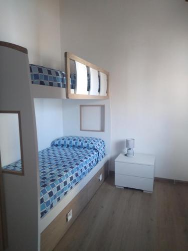 a bedroom with a bunk bed and a mirror at Casa di Anna in Baunei