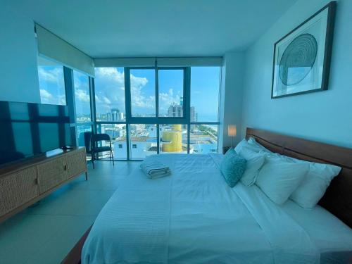 sypialnia z dużym łóżkiem i dużym oknem w obiekcie Monte Carlo Suites in Miami Beach w Miami Beach