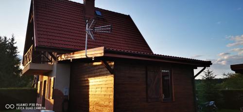 a small house with a roof on top of it at Domek letniskowy nad jeziorem Mazury in Ostróda