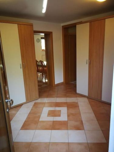 an empty room with doors and a tile floor at Snoopy House in Žužemberk